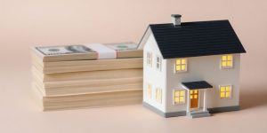 Stack of money, small house.